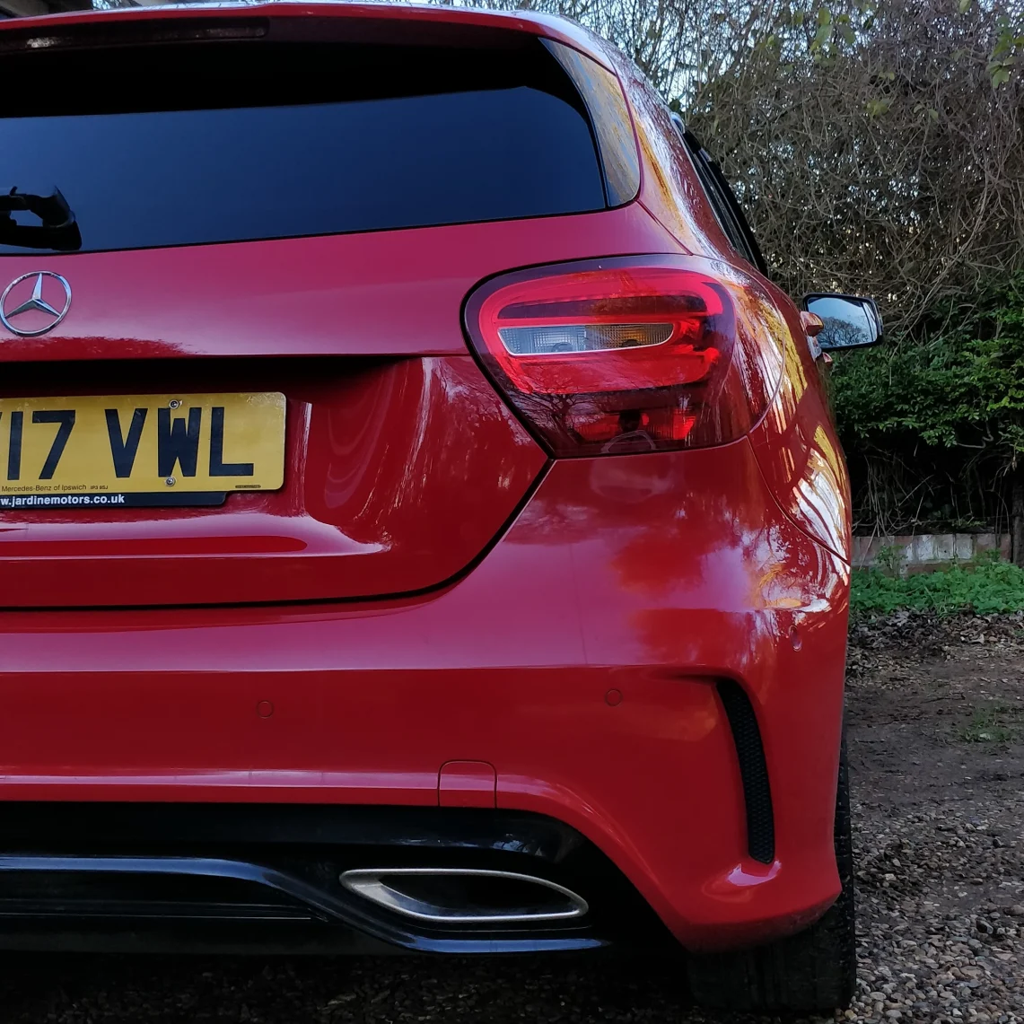Cropped photo of a red Mercedes-Benz A Class car after being washed